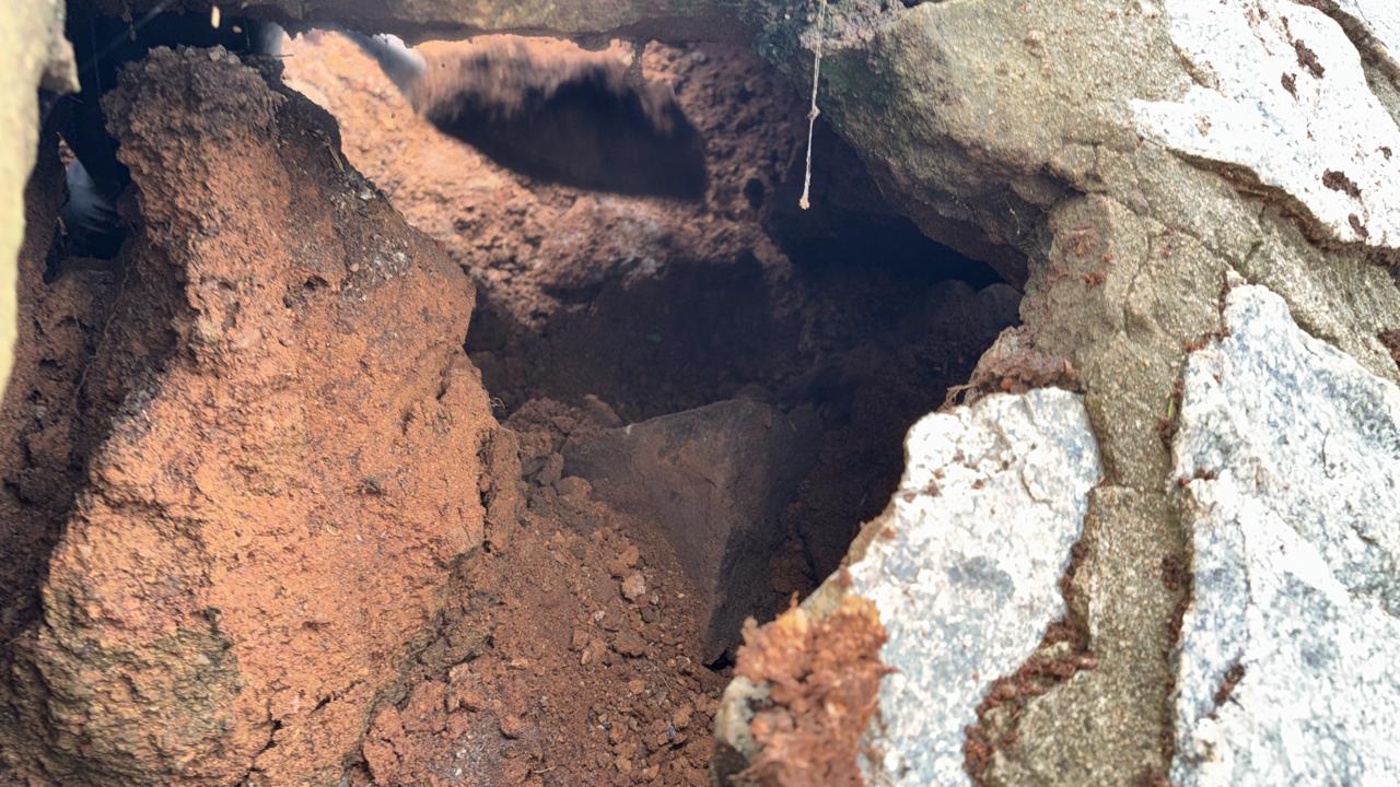 Looking into the cavity beneath the dam wall stonework