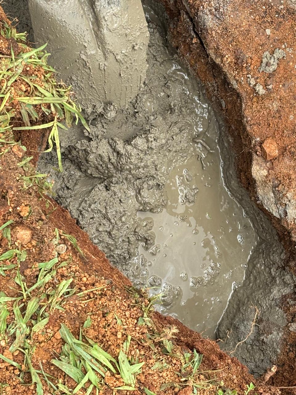 Pumped concrete filling the excavated cavity at the dam wall